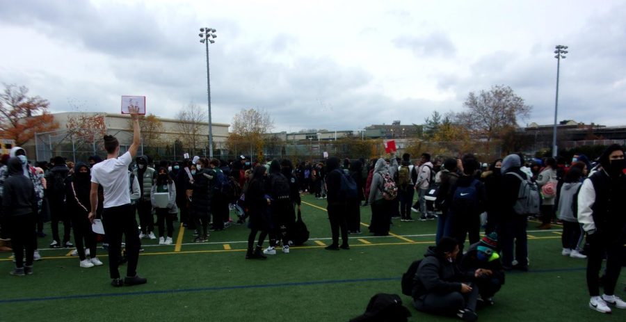 Students line up on the football field during an emergency evacuation. 