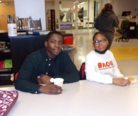 Mr. Kojo Dadzie, the college advisor, sits with Sharlese Edwards, at a senior breakfast.