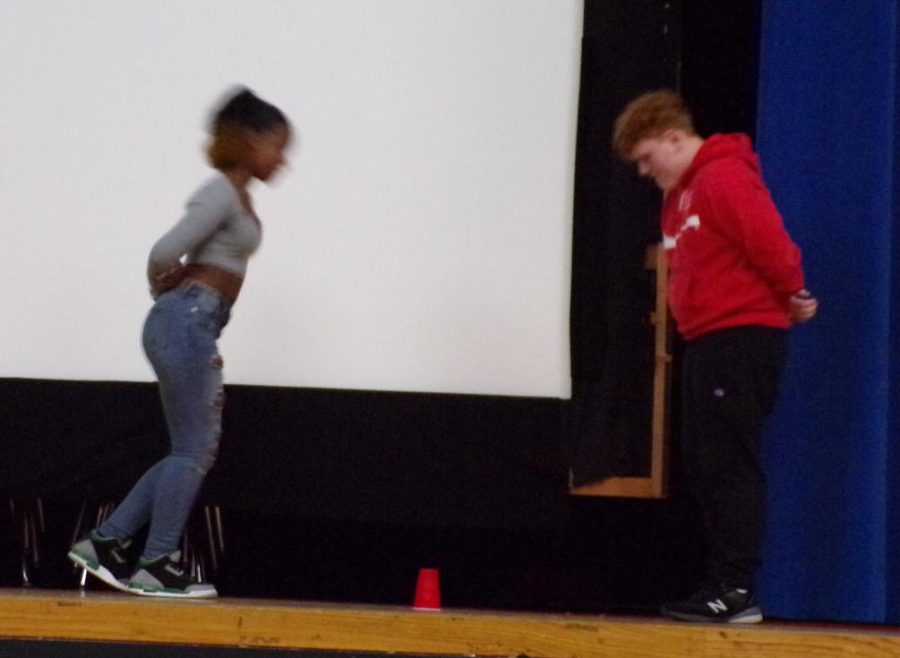 Students compete in the popular cup game.