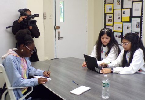 Students work on story ideas as News 12 records the conversations.