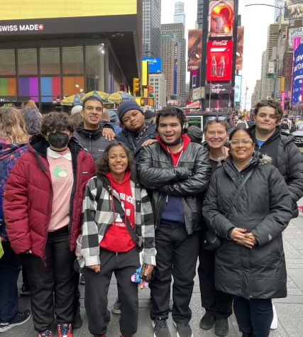 Students and staff enjoy the sights in Time Square while walking to the theater after lunch. 