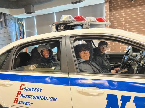 Students get a chance to take a ride in a police car  at the  police academy in College Point.