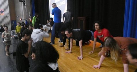 Spotters help keep count as students and staff compete in the push-up challenge. 