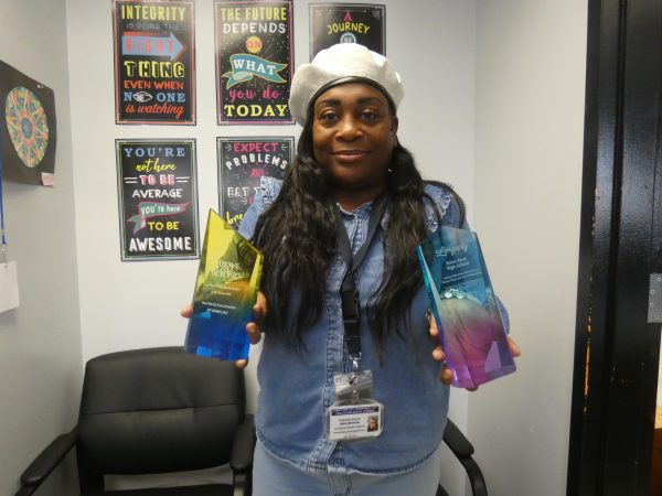 Nakia McKenzie shows off the awards given to BRHS.