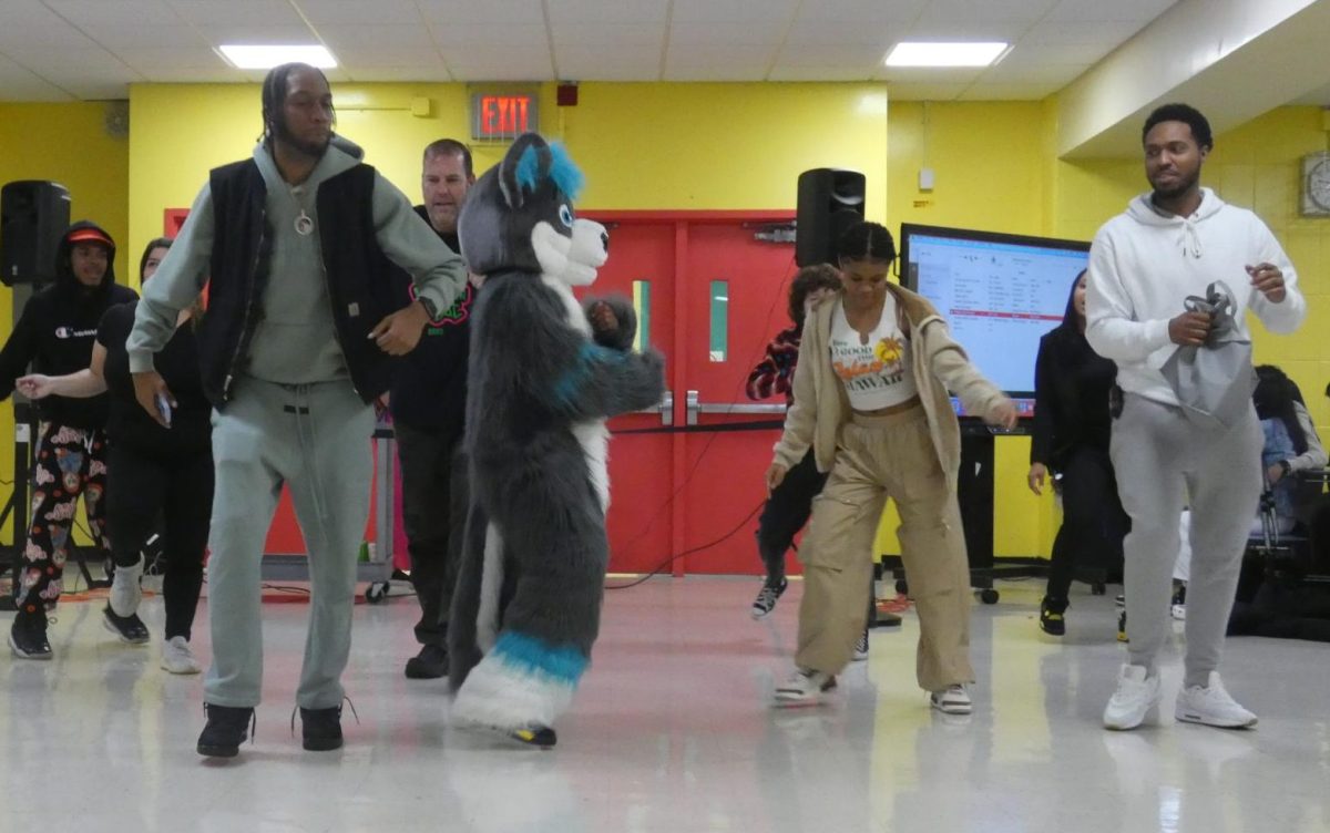 Students and staff dance with the BRHS mascot.