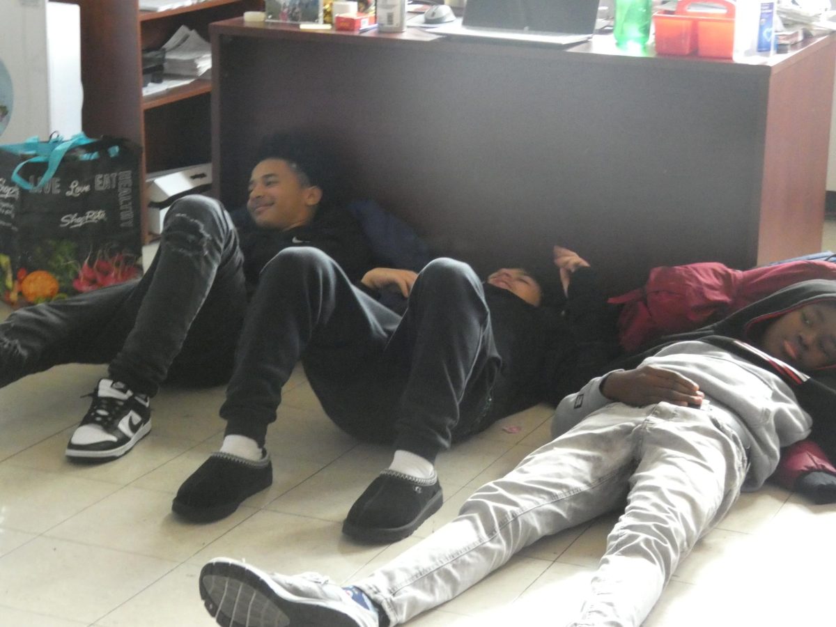 Students take it easy after indulging in the potluck celebration.