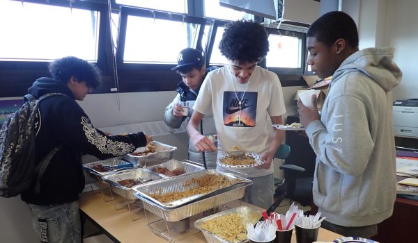 Students pile their plates high during the potluck celebration. 