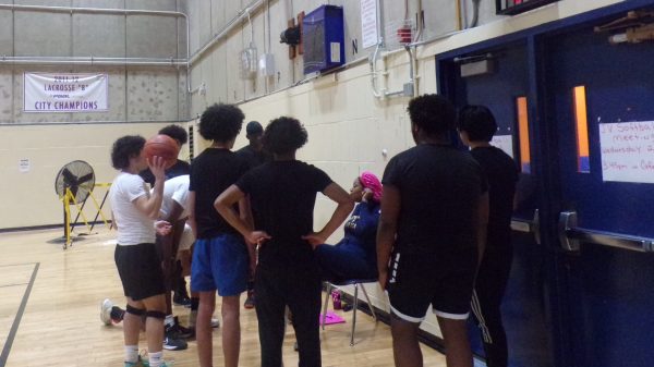 Tenth graders gather round to listen to their coachs instructions.