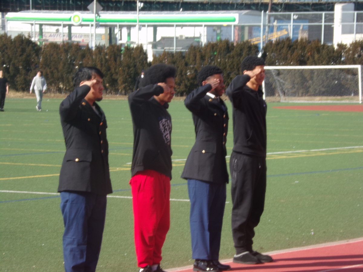 Students in the JROTC program practice marching drills on the football field. 