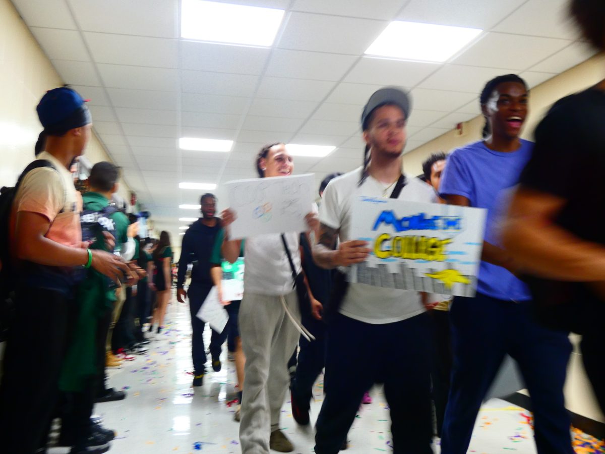Students and staff cheer as students share their college choices in a march around the school.