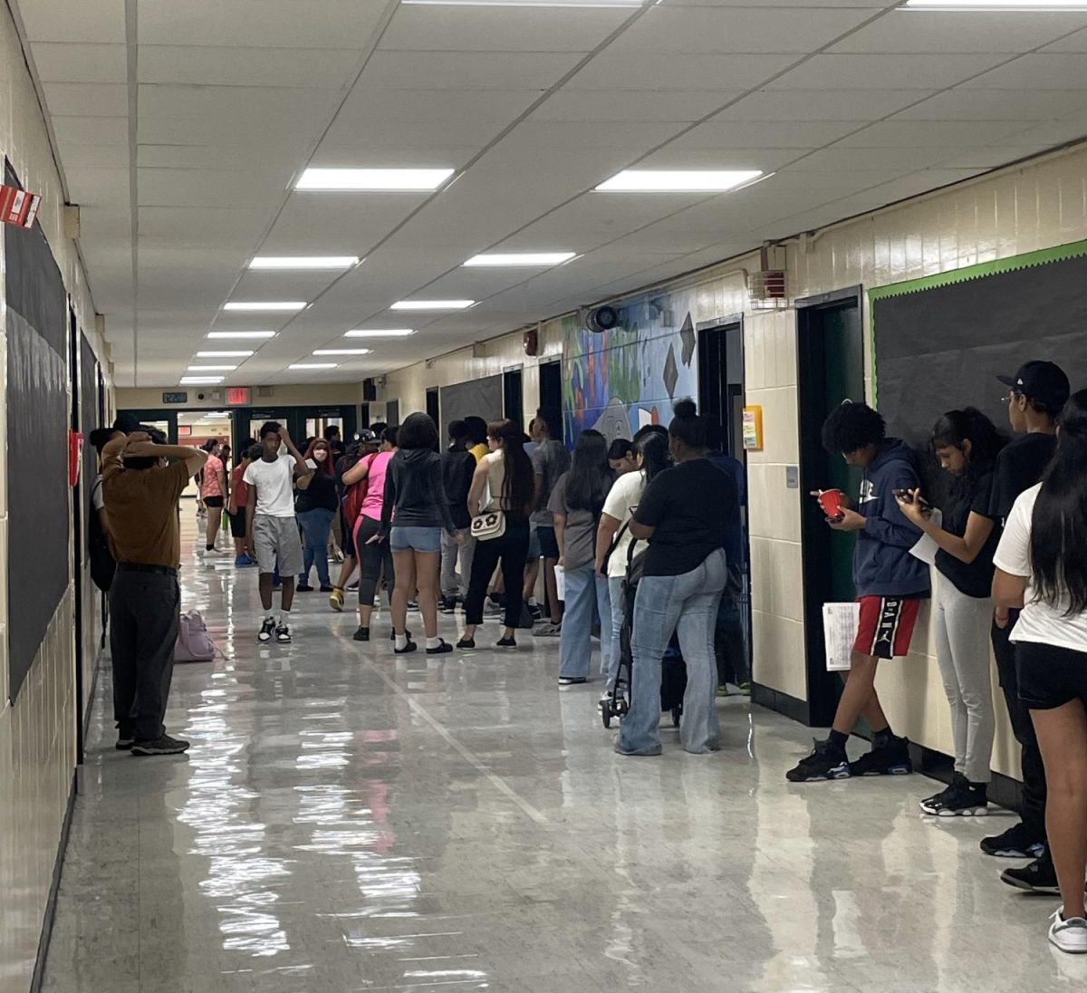 Incoming freshman and their parents line up before the start of school to prepare for the new year. 