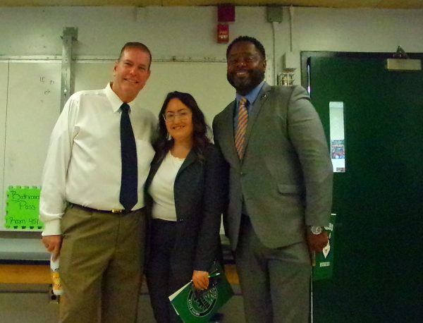 Principal Gregory Fucheck welcomes Chancellor Melissa Aviles-Ramos and superintendent Marcel Deans to the school during the school's literacy showcase.