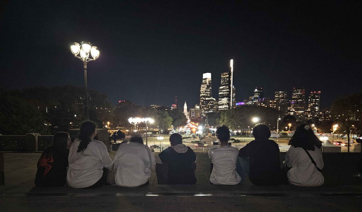 Students enjoy the view from the top of the stairs near the Rocky statue. 