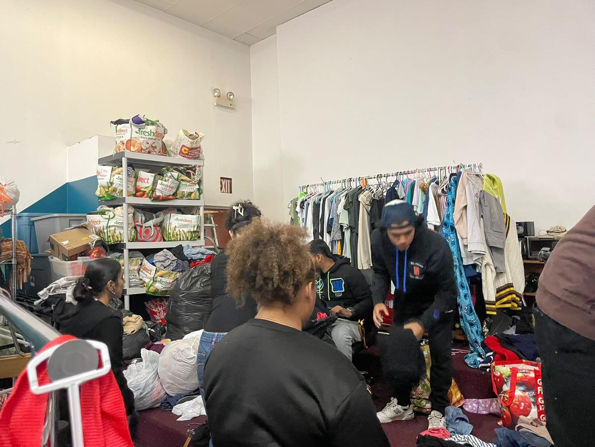 Student volunteers look through clothes at a thrift store.