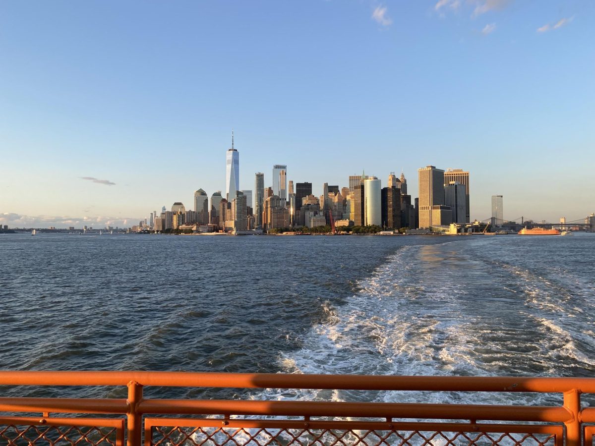 The New York City skyline appears to be floating on water from the Ferry view.

Manhattan buildings are captured more brightly in sunlight during the day.