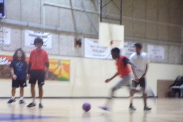 Justin Gomez scores a goal during the upperclassmen vs. underclassmen soccer game as part of the school's winter celebrations. 