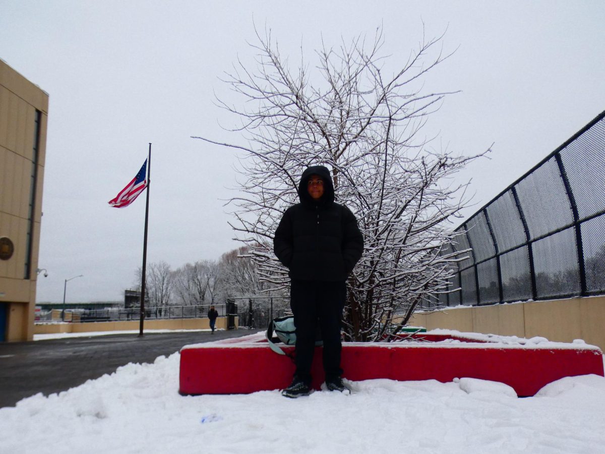 Freshman, David, standing in front of the unexpected winter snow down 