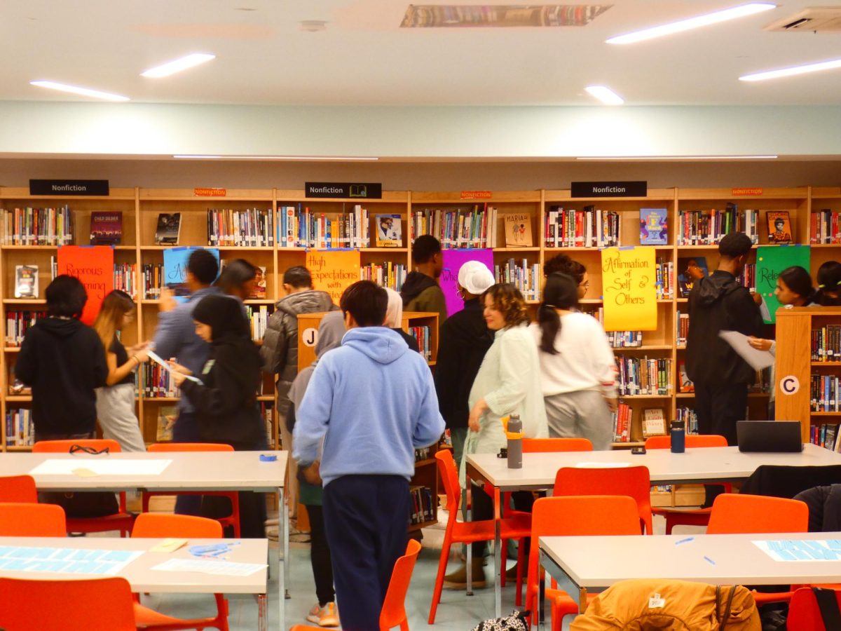 Students choose their top four traits   during a STEAM orientation session in the library in March.