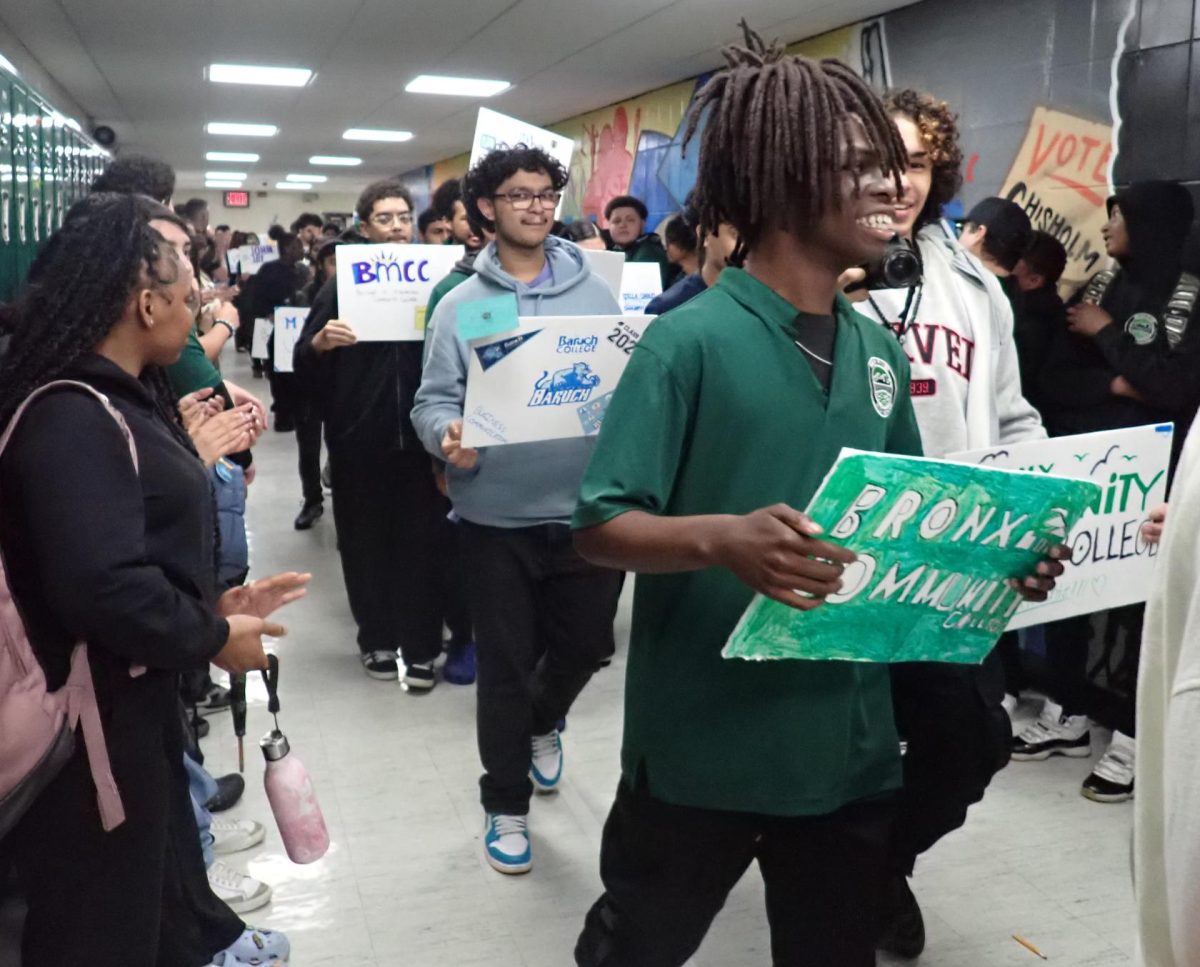 Seniors carry signs highlighting their post-secondary plans during a hallway walk on Decision Day.