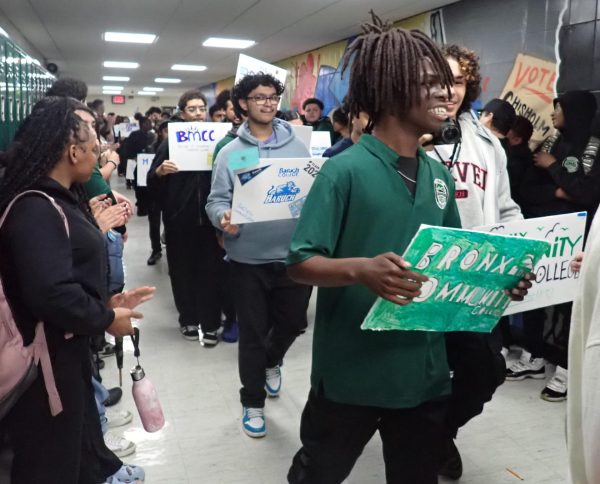 Seniors carry signs highlighting their post-secondary plans during a hallway walk on Decision Day.
