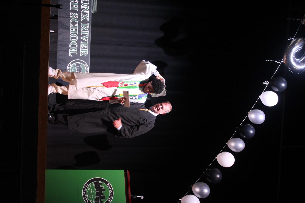 Gregory Fucheck presents the Ryan J. Walsh Scholarship in US History to Justin Sadiel Arias Dias. 
