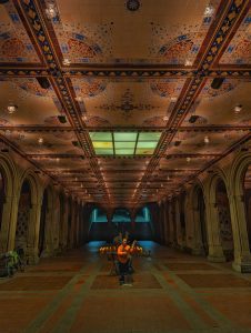 Central Park's Bethesda Terrace guitarist welcomes visitors with stunning melodies.