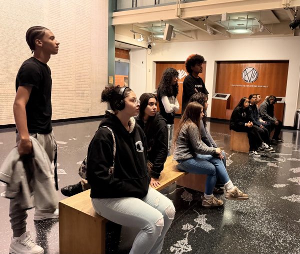 Students learn how the Anne Frank exhibit in Manhattan was put together before starting the tour.