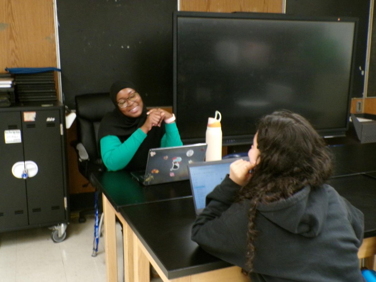 Aye Bah, the new college advisor, meets with seniors to help them with their post-secondary plans. 