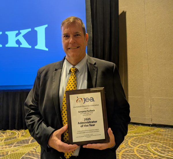 Principal Gregory Fucheck accepts the JEA's Administrator of the Year award at the journalism fall conference in Nashville.