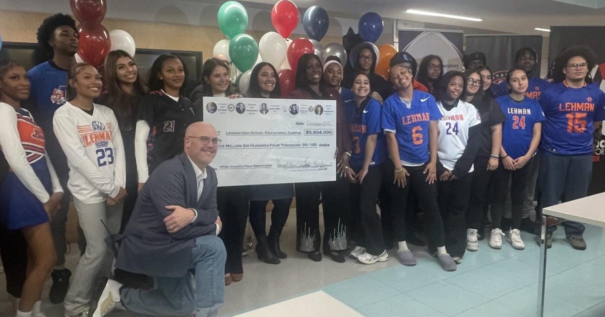 Lehman athletes and supporters of the athletic renovations hold up a symbolic check for $5.6 million during a press event at the Lehman campus on Dec. 17. 