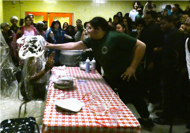 The entire cafe counts as lucky as a  brave sophomore, Jose Rosa,  pays $65 to pie Takia Gaynor straight in the face during the student council's Pi Day festivities on March 13. 