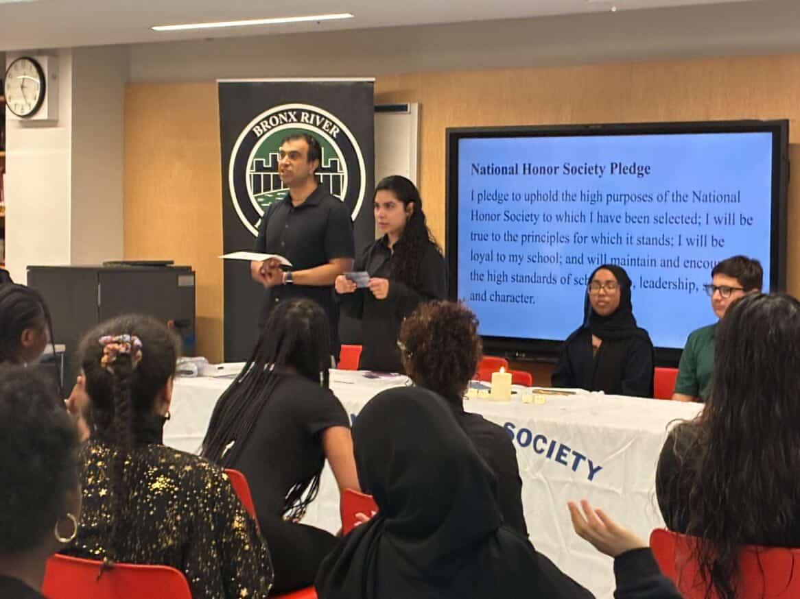 Charley Ruperto and Myess Hammouri announce the members before presenting certificates to the  new members of  National Honor Society.
