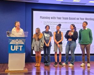 Members of the Bronx River News team join their advisor, Deborah Porterfield, on stage to accept an award at a retreat for student journalists in NYC.
(Photo courtesy of Press Pass NYC)